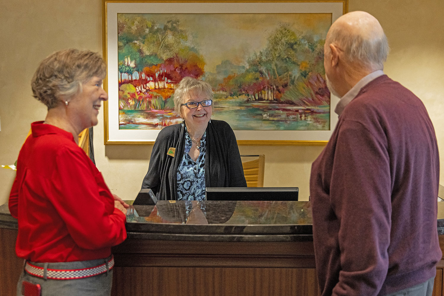 Senior couple speaking with a staff member at Lake Forest Place